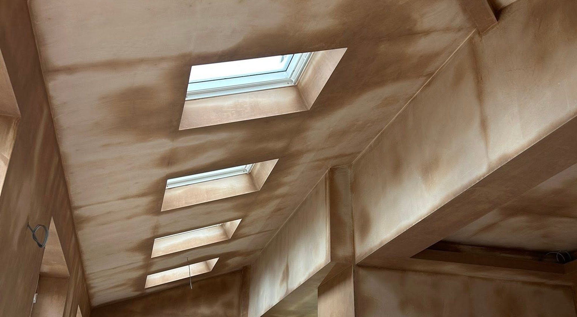 Freshly plastered interior with a series of rooflights